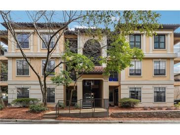 Inviting multi-story condo with a manicured lawn, trees, and traditional architectural features at 3777 Peachtree Ne Rd # 911, Atlanta, GA 30319