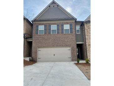 Two story brick home with a 2 car garage and dark shutters on the upper windows at 2677 Pearl Ridge Trce, Buford, GA 30519