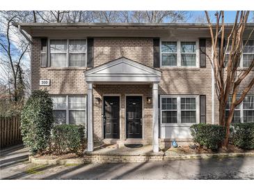 Charming brick townhome with a covered entrance and black shutters at 2232 Dunseath Nw Ave # 302, Atlanta, GA 30318