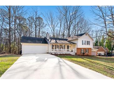 Charming exterior of this two-story home featuring a cozy front porch and attached two-car garage at 548 Slew Ave, Lawrenceville, GA 30043