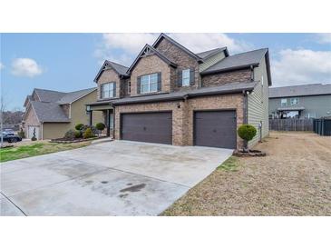 Two-story home featuring a brick and siding exterior, attached two-car garage and concrete driveway at 1160 Faulkner Way, Jonesboro, GA 30238