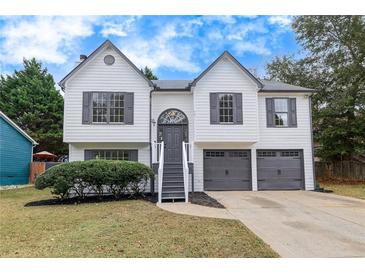 Charming two-story home featuring a manicured lawn and an attached two-car garage at 2954 Lighthouse Ct, Acworth, GA 30101
