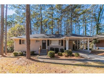 Charming brick ranch-style home with a covered carport and well-maintained landscaping at 2777 Luther Dr, Atlanta, GA 30344