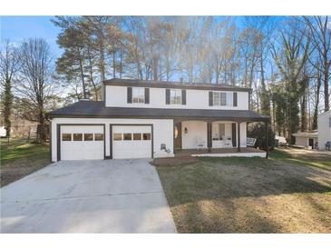 Charming two-story home featuring a covered front porch, two-car garage, and a well-maintained front lawn at 6746 Windfaire Dr, Norcross, GA 30093