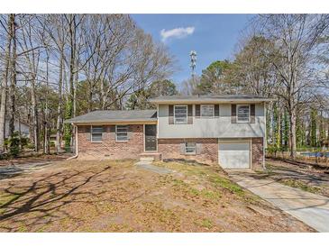 Traditional two-story home featuring a brick and siding exterior with an attached garage at 810 N Carter Dr, Jonesboro, GA 30236