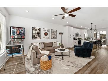 Spacious living room featuring an open floor plan, modern decor, and beautiful hardwood floors at 511 Burton Dr # 805, Alpharetta, GA 30009