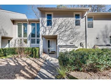 Charming townhouse with meticulously maintained landscaping, inviting entrance, and bright, neutral exterior at 2000 Variations Dr, Atlanta, GA 30329
