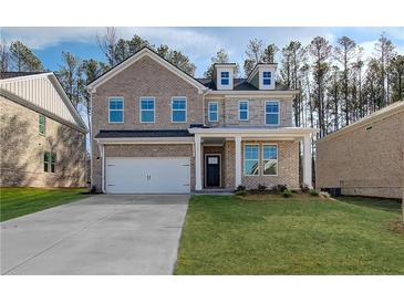 Charming two-story brick home featuring a two-car garage and well-manicured lawn at 117 Belvedere Rd, Mcdonough, GA 30253