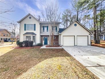 Charming two-story home with a two car garage and front-facing balcony, perfect for enjoying the outdoors at 4969 Portsmouth Ct, Lithonia, GA 30038
