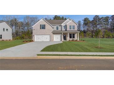 Charming new two-story home featuring a three-car garage, gray brick and siding, and a well-manicured lawn at 112 Felicity Pike, Locust Grove, GA 30248