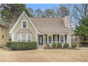 Charming home featuring a well-manicured front yard, a quaint porch, and a classic suburban aesthetic at 1474 Benjamin Sw Ct, Marietta, GA 30064