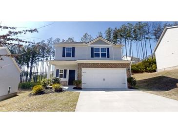 Charming two-story home with covered porch, brick accents, and an attached two-car garage at 1010 Nandina Ct, Villa Rica, GA 30180