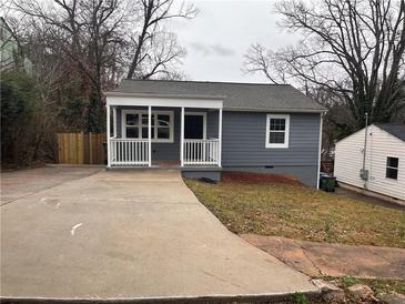 Charming single-story home featuring a covered front porch, concrete driveway, and gray siding at 197 Upshaw Sw St, Atlanta, GA 30315
