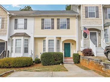 Charming townhome with a bright yellow facade, neat landscaping, and a welcoming green front door at 103 Timber Ridge Dr, Cartersville, GA 30121