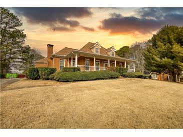 Charming brick home with inviting front porch and meticulously maintained landscaping at 5770 Wyndemere Ln, Stone Mountain, GA 30087