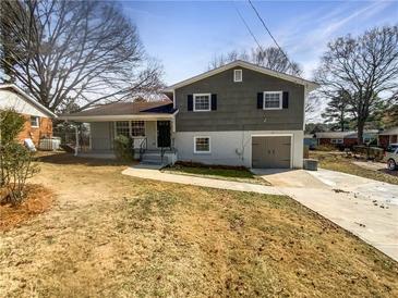 Charming two-story home with covered porch, single car garage, and beautiful yard at 6296 Flamingo Way, Morrow, GA 30260