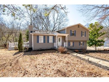 Charming split-level home with gray siding, blue shutters, and a well-manicured front yard at 975 Malibu Dr, Marietta, GA 30066