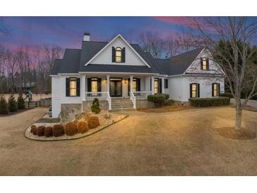 Beautiful two-story home with a manicured lawn and charming curb appeal featuring a stone foundation at 102 Rosebury Dr, Canton, GA 30115