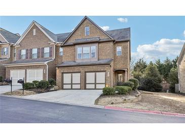 Two-story brick home with a two-car garage, manicured landscaping, and a welcoming front entrance at 220 Ashley Se Ln # 19, Smyrna, GA 30080