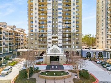 Attractive condominium building exterior with well maintained grounds, water feature, and covered entrance at 799 Hammond Dr # 305, Atlanta, GA 30328