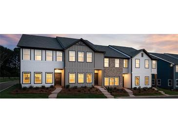 Exterior view of newly built townhomes with varied facades and professionally landscaped yards at 2107 Stillhaven Pl, Douglasville, GA 30135