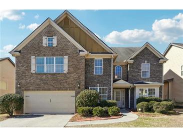 Charming two-story home with a well-manicured front yard and brick and stone facade at 1309 Avington Glen Dr, Lawrenceville, GA 30045