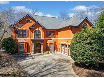 Elegant two-story home with a driveway and a well-maintained yard at 511 Newburgh Way, Roswell, GA 30075