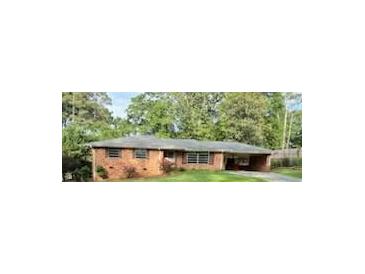 Quaint one-story brick home featuring mature trees and a convenient carport, offering comfort and style at 5535 Beaver Sw Dr, Mableton, GA 30126