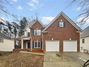 Charming two-story brick home with two-car garage and inviting front porch at 4190 Haynes Mill Nw Ct, Kennesaw, GA 30144