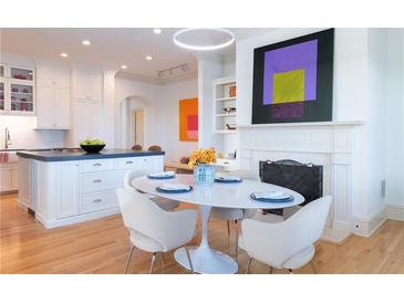 Bright dining area featuring a fireplace, modern lighting, and a table setting for four at 2500 Peachtree Nw Rd # 605S, Atlanta, GA 30305