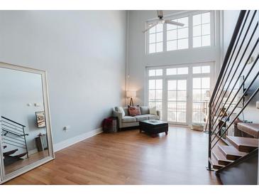 Bright living room featuring hardwood floors, high ceilings, and large windows at 1253 Caroline Street Northeast, Atlanta, GA 30307