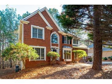 Charming two-story red brick home with manicured landscaping at 514 Lovinggood Ct, Woodstock, GA 30189