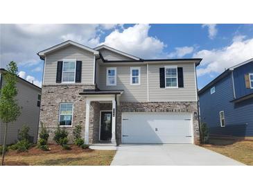 Charming two-story home with brick and siding, complemented by a well-manicured front yard at 7158 Brushwood Bend (110), Lithonia, GA 30058