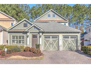 Charming two-story home with a two-car garage and lovely landscaping in front at 505 Rocking Porch Way, Woodstock, GA 30189