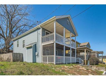 Charming two-story home with a double-decker porch and blue siding at 775 Welch Sw St, Atlanta, GA 30310