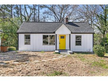 Charming renovated single-story home with a bright yellow front door and fresh landscaping at 174 Howard Nw St, Atlanta, GA 30314