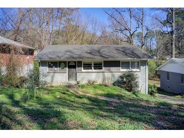 Cozy single-story home with a painted brick exterior and a well-maintained front yard at 1834 Buckeye Sw St, Atlanta, GA 30310