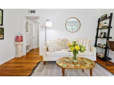 Bright living room with hardwood floors, decorative mirror, and comfortable white couch at 841 Frederica Ne St # 19, Atlanta, GA 30306