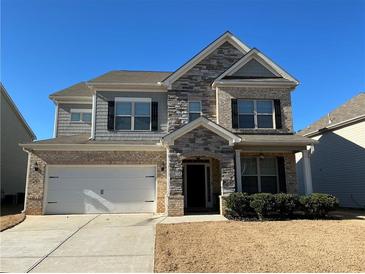 Charming two-story home with stone and siding facade, manicured lawn, and an attached two-car garage at 140 Craines Vw, Covington, GA 30014