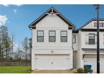 Modern two-story home with white siding, black trim, and a two-car garage at 43 N Auburn Landing Pl, Auburn, GA 30011