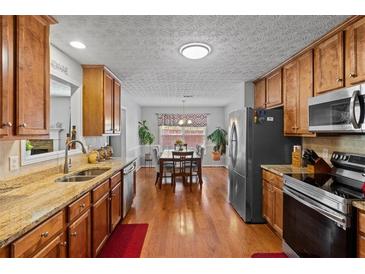 Well-lit kitchen with stainless steel appliances and beautiful granite countertops at 2773 Saddle Horn Place Southwest Pl, Snellville, GA 30039