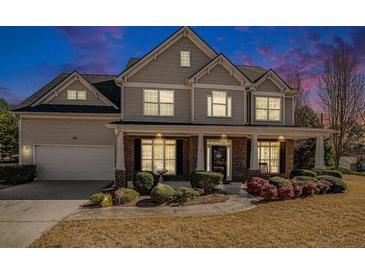 Inviting two-story house with a brick-accented porch and manicured front yard at 1200 St James Pl, Loganville, GA 30052