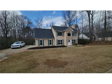 Charming two-story home featuring stone accents, green shutters, and a well-maintained lawn at 1965 Deer Creek Trl, Buford, GA 30519