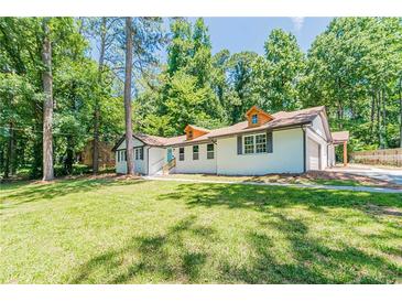 Charming renovated home with lush green lawn and mature trees offering great curb appeal at 313 Linda Dr, Tucker, GA 30084