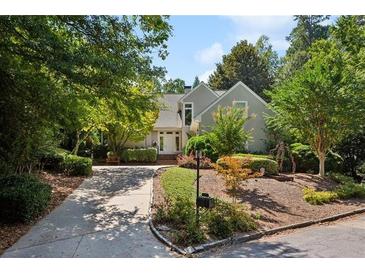 Charming exterior of a well-maintained home with lush landscaping and a welcoming driveway at 857 Stovall Ne Pl, Atlanta, GA 30342