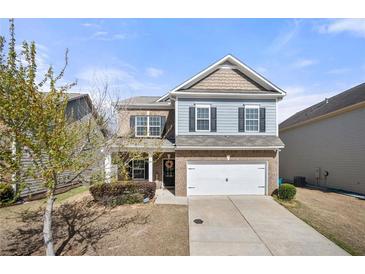 Charming two-story home with a well-manicured front yard and attached two car garage in a quiet neighborhood at 1390 Napa Valley Sw Dr, Lawrenceville, GA 30045