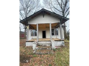 Modest home featuring a gabled roof and inviting front porch; a fixer upper awaiting renovation to restore its charm at 1406 Allene Sw Ave, Atlanta, GA 30310