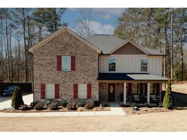 Charming two-story home featuring a brick facade, covered front porch, and beautifully landscaped yard at 139 6Th St, Auburn, GA 30011