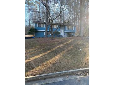 Charming two-story home with a blue exterior and a well-manicured front yard at 3630 High Point Sw Ln, Atlanta, GA 30331