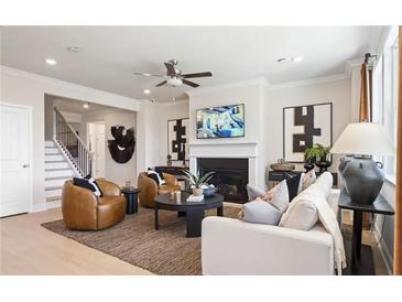 Inviting living room features a cozy fireplace, stylish decor, and comfortable seating, perfect for relaxation at 3119 Shirecrest Ln, Dacula, GA 30019